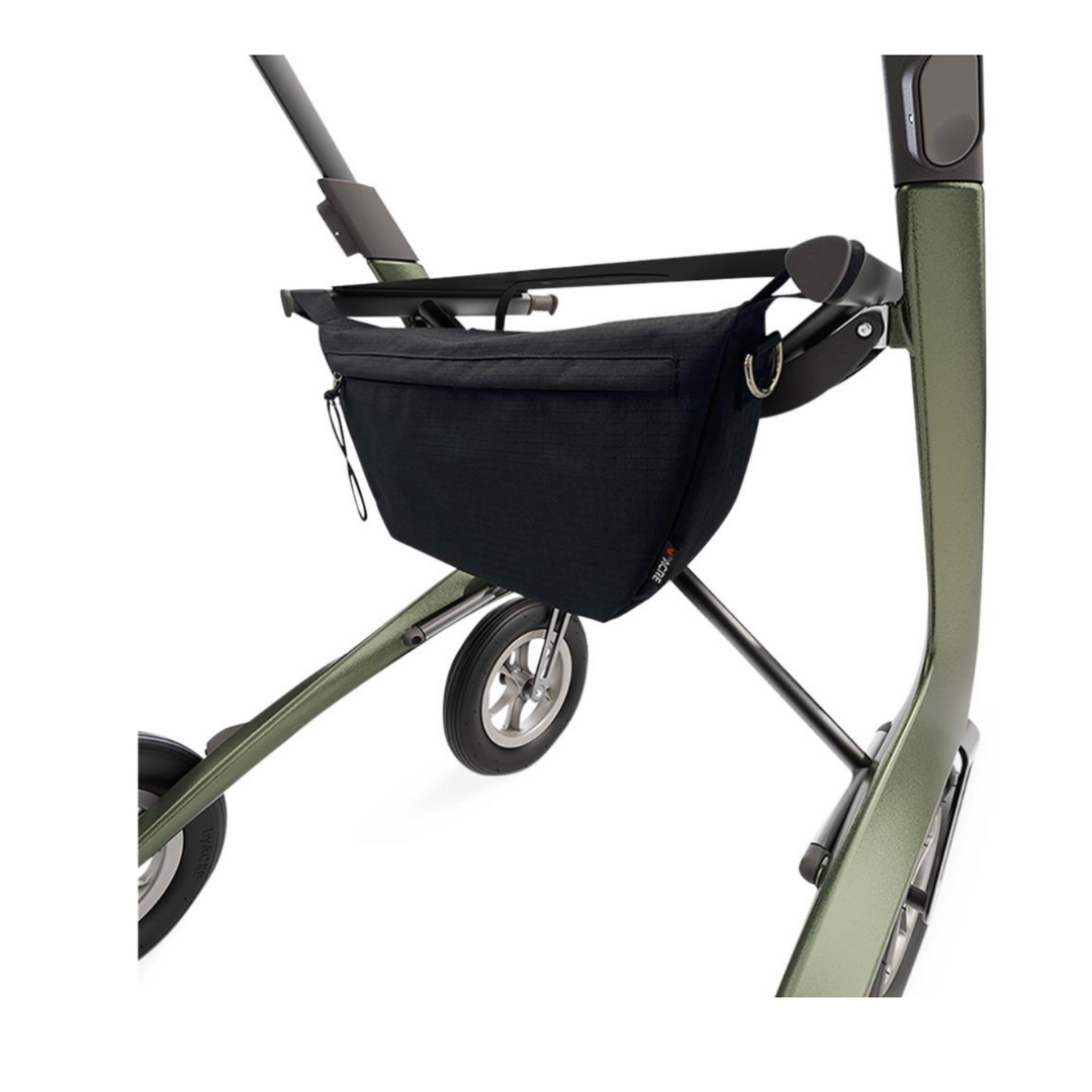 A close-up showcases the sleek ByAcre Overland Carbon Fiber Rollator in green, featuring sturdy black wheels and a practical black bag underneath, merging style and function for everyday mobility.